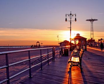 The sun sets over the Coney Island Boardwalk. (Credit: New York Habitat)