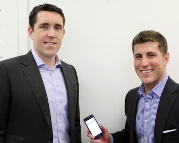 View the Space's Andrew Flint (left), the head of business development, and Ryan Massiello, the chief revenue officer with the new mobile app on his phone