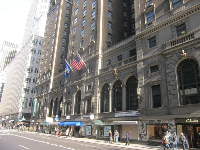 A large hotel along a sidewalk.