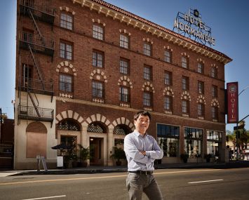 Jingbo Lou outside the renovated Hotel Normandie (Photo: Rocco Ceselin for Commercial Observer).