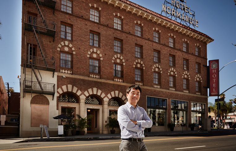 Jingbo Lou outside the renovated Hotel Normandie (Photo: Rocco Ceselin for Commercial Observer).