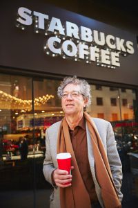 
SCG Retail’s David Firestein, holding his flat white coffee, hits a Starbucks 
in person at least once daily (Photo:
Yvonne Albinowski/for Commercial Observer).