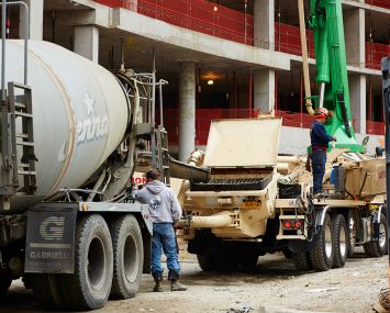 Jenna Concrete is providing the cement for 2040 Frederick Douglass Boulevard, a 38-unit apartment building. Each truck carries 11 cubic yards of concrete 
(Photo: Yvonne Albinowski/for Commercial Observer).