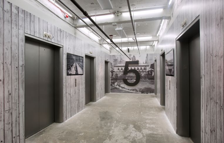 The elevator area of the ninth floor was covered with faux-wood wallpaper (Photo: Kevin Chu and Sharon Mclaughlin).
