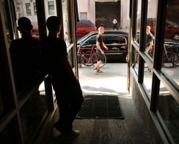 People walk on a popular shopping street in Dumbo in the Brooklyn borough of New York City. What was once a sleepy manufacturing hub with cobblestone streets and derelict old factories has become one of the trendiest locations in New York City (Photo: Spencer Platt/Getty Images).