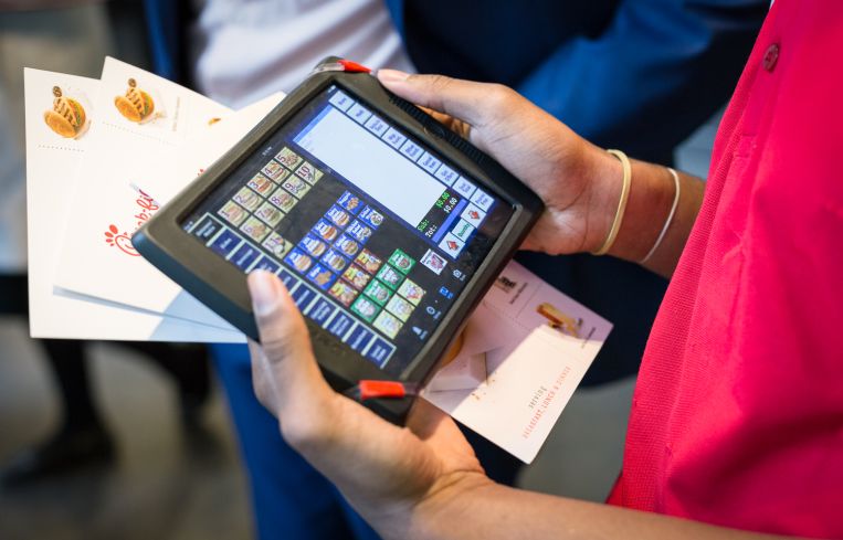 Customers in line get their order taken on iPads by employees at Chick-Fil-A at 1000 Ave of the Americas in Manhattan on 5 May 2016. Photo: Kaitlyn Flannagan for Observer