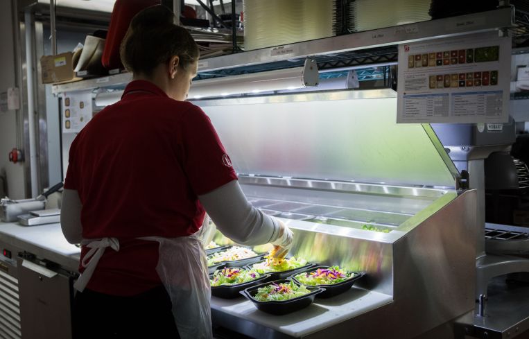 Employee makes salad in the basement kitchen of Chick-fil-A at 1000 Avenue of the Americas (Photo: Kaitlyn Flannagan/Commercial Observer).