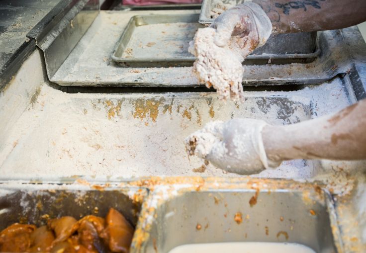 Employee coating the chicken breasts in what is considered Chick-fil-A's "secret sauce" at 1000 Avenue of the Americas (Photo: Kaitlyn Flannagan/Commercial Observer).