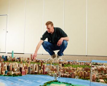 Joe Macken with his mini-Manhattan structure (Photo: Yvonne Albinowski/ For Commercial Observer).