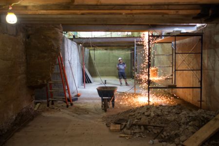 A worker in the basement watches as a colleague welds above him at 599 Johnson Ave. in Bushwick (Photo: Aaron Adler/ for Commercial Observer).