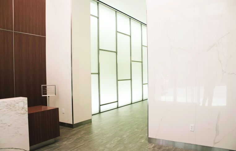 The new lobby of 45 West 45th Street features wood and marble-like panels (Photo: Jemma Dilag/ For Commerical Observer).