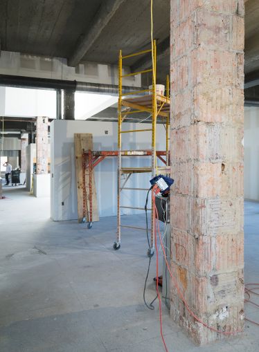 The office's columns were stripped revealing terra-cotta-covered steel beams (Photo: Kaitlyn Flannagan/ For Commercial Observer). 