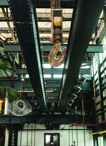 One of the old gantry cranes in Building 128,  which are now used to suspend three bridges across New Lab in the Brooklyn Navy Yard. Photo: Emily Assiran/Commercial Observer