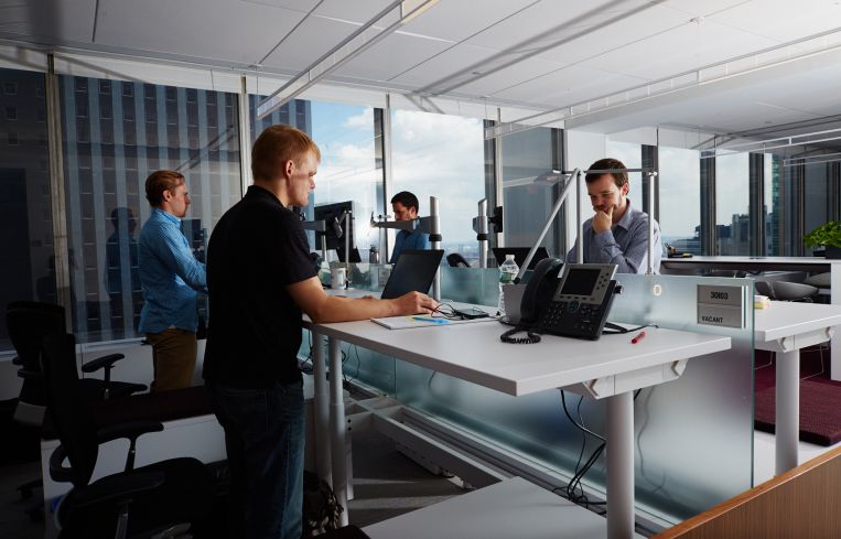 Standing desks help workers maintain healthy bodies.