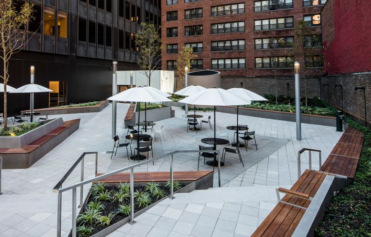 The plaza is now filled with more seating, planting beds and tables with umbrella covers. Photo: Alan Schindler.
