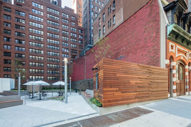 An Ipe wood designed wall replaced a brown brick wall that limited entry into the plaza. Photo: Alan Schindler.