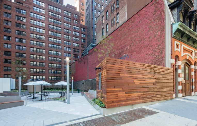An Ipe wood designed wall replaced a brown brick wall that limited entry into the plaza. Photo: Alan Schindler.