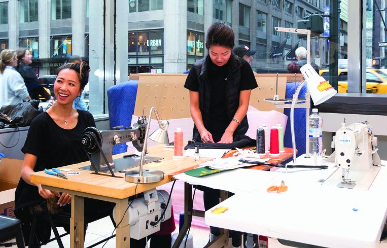 Seamsters are in the store to sew on custom patches on customer's jackets and other products. Photo by Eugene Gologursky/Getty Images for The North Face.