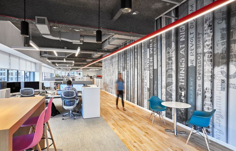 The office has open layout with exposed ceilings. Photo: Garrett Rowland.