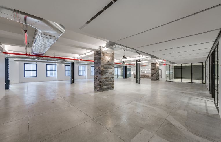 Wood panels have been added to some columns and others have been stripped down to reveal steel. Photo: JEMB Realty