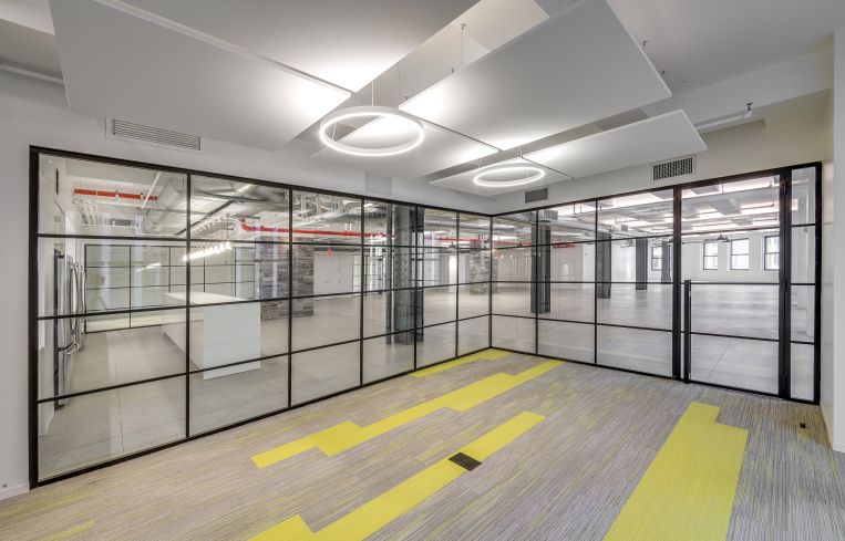 The glass walls have a black steel incorporated in the pattern to make it look different from other modern glassed offices. Photo: JEMB Realty
