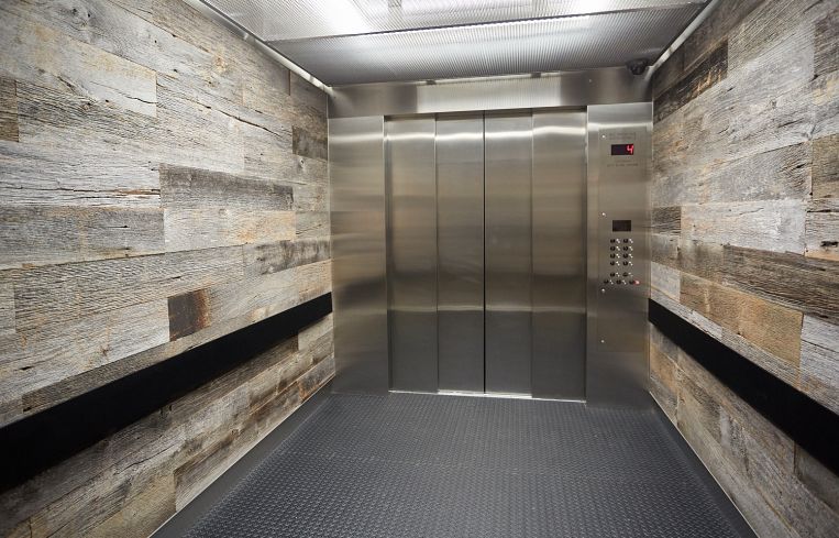 Elevator interiors at the Bruckner Building feature reclaimed wood siding. Photo: Harry Zernike/ for Commercial Observer.