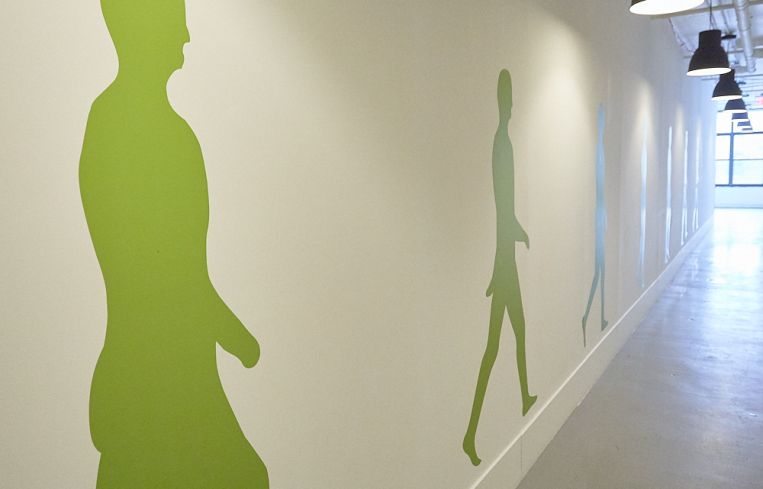4th floor corridor, which has lime green figures painted on it. Photo: Harry Zernike/ for Commercial Observer.