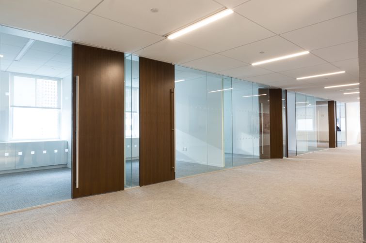 Private offices which feature glass walls to let light into the common areas of the office on the 19th floor. Photo: Melissa Goodwin/For Commercial Observer