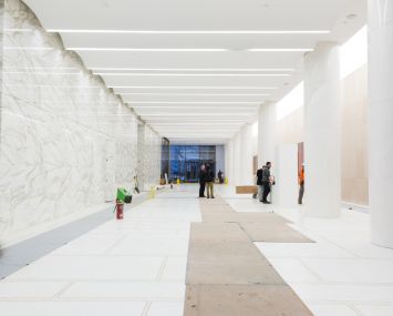 75 Rockefeller Plaza's new lobby. Photo: Melissa Goodwin/For Commercial Observer. Under Construction; 75 Rockefeller Plaza, New York, NY. Workers put the finishing touches on the lobby at 75 Rockefeller Plaza