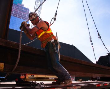 New York City ironworker readies steel for crane lift. Photo Courtesy of Joe Woolhead