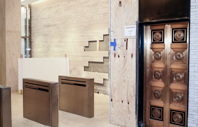 The only historical thing landlords could save from 40 Exchange Place was the brass elevator doors. Photo: Robert Paul Cohen/For Commercial Observer
