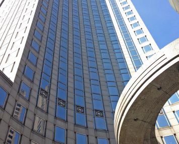 A soaring skyscraper closeup, looking up from the ground.