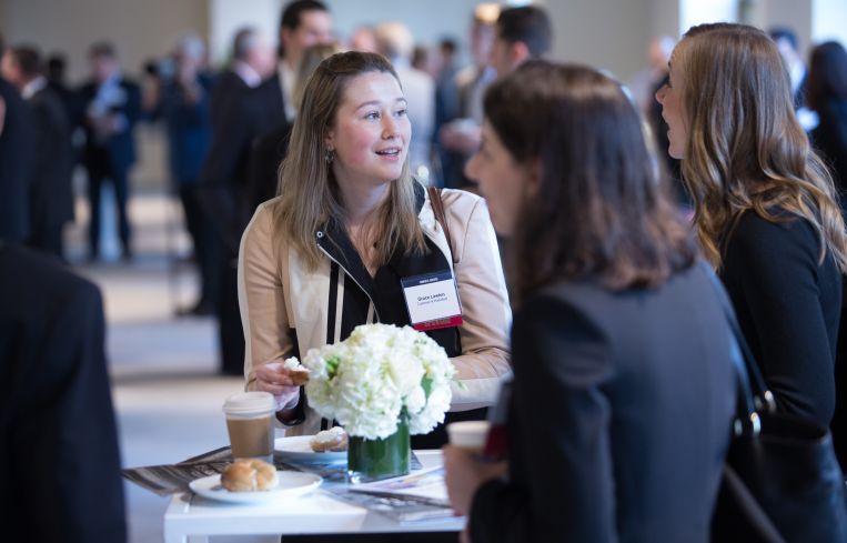 Real estate pros mingle before the event.