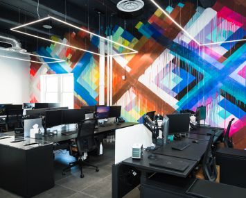 Meadows Office Interiors new location at 625 West 55th Street features open work stations and an art wall.