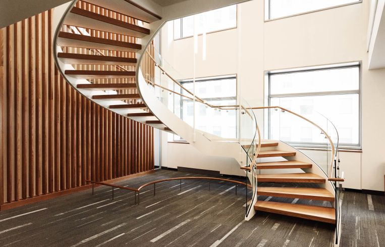 A spiral staircase made from wood is just one ways the university incorporated the sustainable material throughout the building.