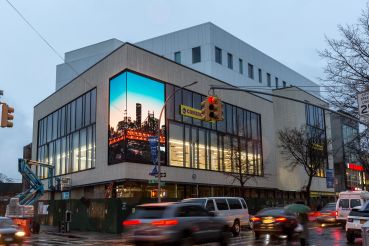 The exterior of 1601 Kings Highway in Sheepshead Bay features a two-sided video screen.