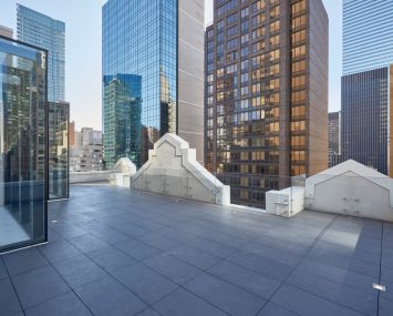 The renovated penthouse has a terrace overlooking Midtown.