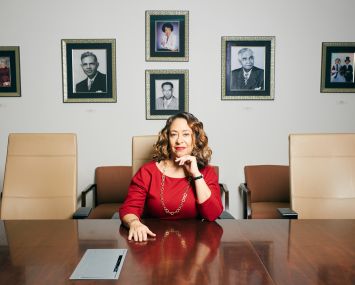Cheryl McKissack Daniel in the main conference room of her firm McKissack & McKissack, where pictures of her family members are hanging from the wall.