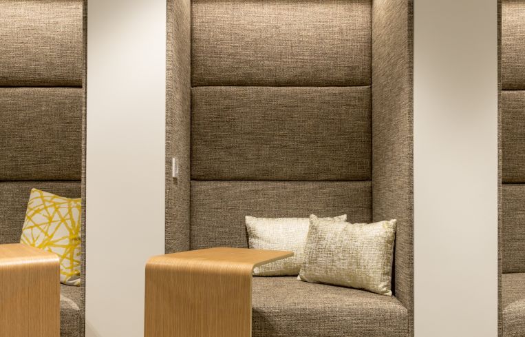 The fabric paneled walls inside the small work booths offer coworking members quiet privacy.