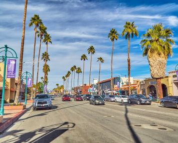 Palm trees line the city streets of the city of Palm Springs, California.