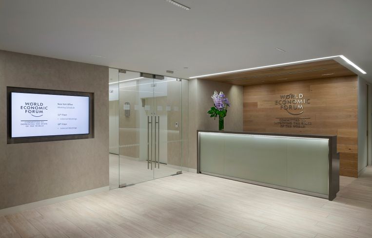 The reception desk has a glass front panel.