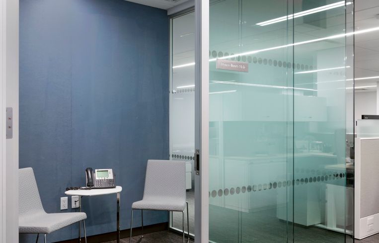 The office has small meeting spaces away from workstations.