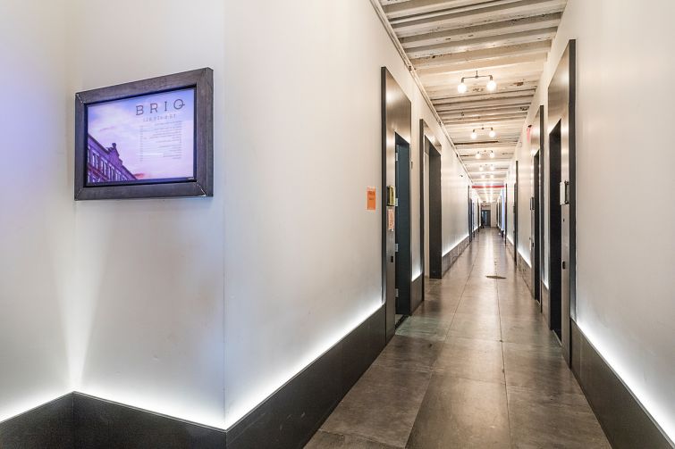 The Briq Building hallways have polished concrete and wooden joists. 