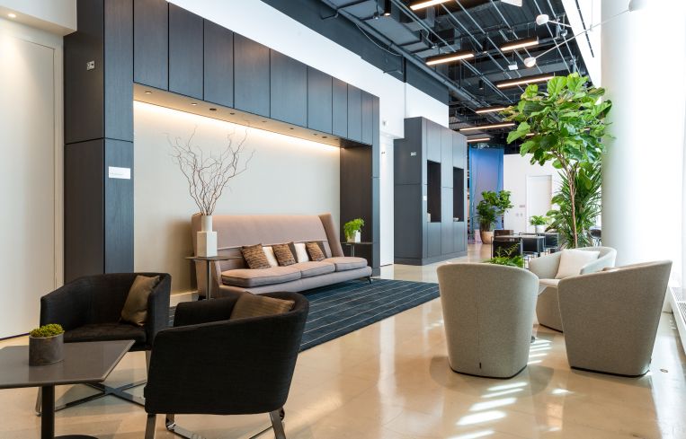 Long couches and groupings of chairs provide a variety of spaces for collegues to meet in at the Convene/Well & amenity floor at 4 Times Square.