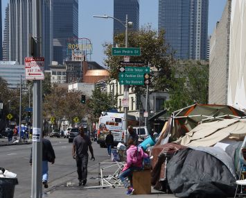 Los Angeles financial district skyscrapers are seen behind a homeless tent encampment in downtown Los Angeles.