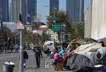 Los Angeles financial district skyscrapers are seen behind a homeless tent encampment in downtown Los Angeles.  