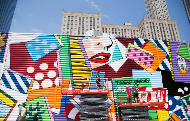 Todd Gray puts the finishing touches on a mural adorning a temporary construction shed at the World Trade Center.