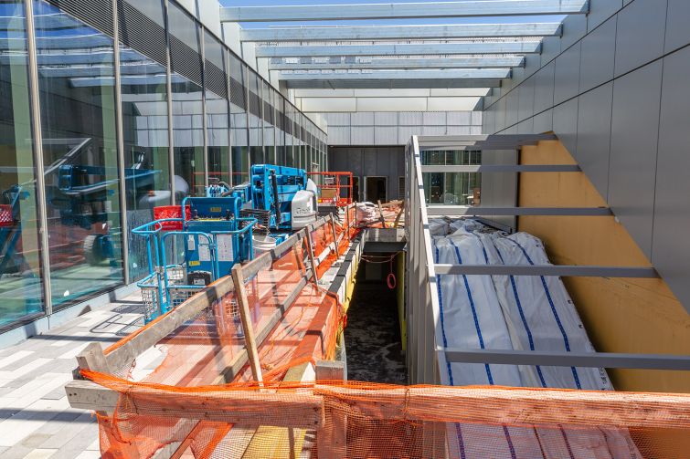 The escalator structures at Empire Outlets will all be wrapped in orange glass, similar to the color of the Staten Island Ferry.
