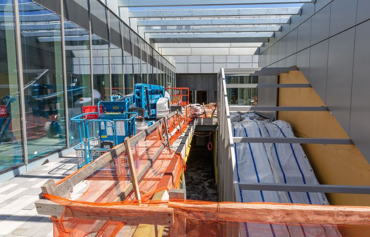 The escalator structures at Empire Outlets will all be wrapped in orange glass, similar to the color of the Staten Island Ferry.