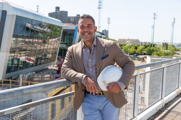 Joseph Ferrara of BFC Partners with his Empire Outlets project behind him.